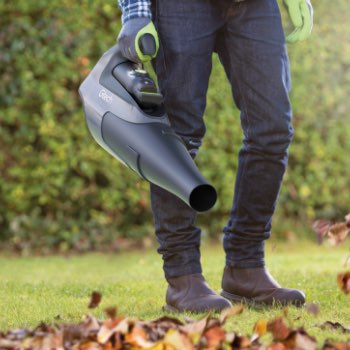 close up of cordless leaf blower on autumn leaves