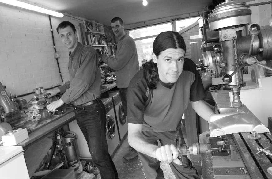 Picture of Nick Grey and colleagues working together in the garage