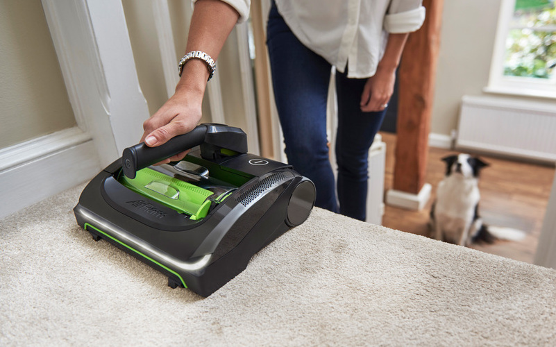 close up image of woman hoovering stairs