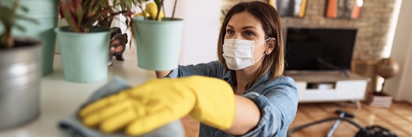 person cleaning in a mask